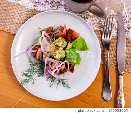 Pieces of avocado, tomato and onion rings served in a plate Pieces of avocado, tomato and onion rings served in a plate 106953065