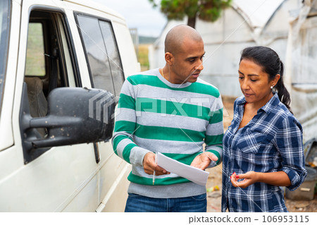 Man and woman farmers talking near car Man and woman farmers talking near car 106953115