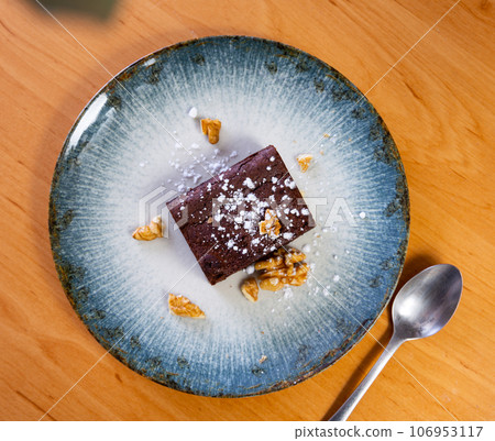 Piece of brawny with walnuts served in a plate Piece of brawny with walnuts served in a plate 106953117