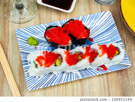 Urumaki roll with salmon avocado pepino and tobiko Urumaki roll with salmon avocado pepino and tobiko 106953149