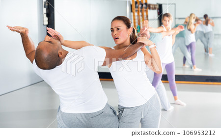 Latin american woman practicing palm strike in self defense training Latin american woman practicing palm strike in self defense training 106953212