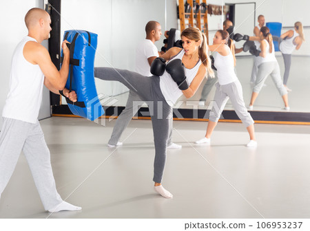 Ordinary hispanic woman working with trainer Ordinary hispanic woman working with trainer 106953237