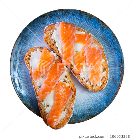 On table there is plate with homemade light snack - toast, crispy salmon sandwiches On table there is plate with homemade light snack - toast, crispy salmon sandwiches 106953238