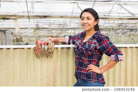 Portrait of a smiling woman in greenhouse Portrait of a smiling woman in greenhouse 106953240