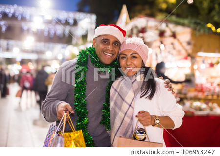 Portrait of couple with Christmas toys at fair outdoor Portrait of couple with Christmas toys at fair outdoor 106953247