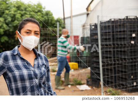 Portrait of woman farmer wearing protective mask in the backyard of house Portrait of woman farmer wearing protective mask in the backyard of house 106953268