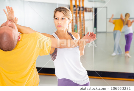 Girl using palm to launch blow in chin during self defence training Girl using palm to launch blow in chin during self defence training 106953281
