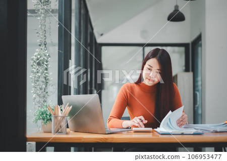 Portrait of Young Successful Caucasian Businesswoman sitting at desk working on laptop computer. Ambitious Corporate Manager Plan Investment Strategy for e-Commerce Project. 106953477