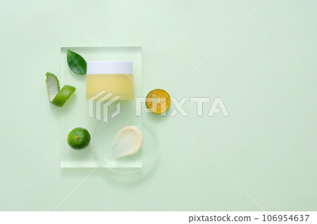Mockup packaging, cosmetic jar unbranded for design is displayed on transparent podium with slices of kumquat. Concept for advertising natural cosmetic 106954637