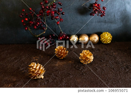 red berries and golden pine cones 106955071