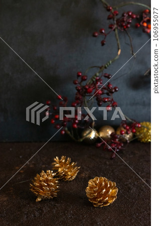 red berries and gold pine cones 106955077