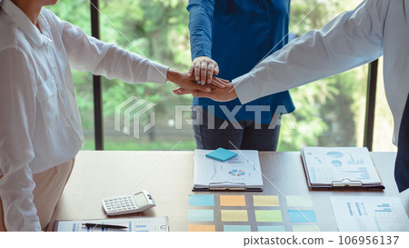 Group of business colleague stack hands together while discussing and coworking about new business Group of business colleague stack hands together while discussing and coworking about new business 106956137