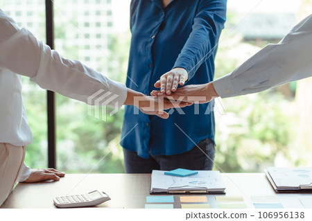 Group of business colleague stack hands together while discussing and coworking about new business Group of business colleague stack hands together while discussing and coworking about new business 106956138
