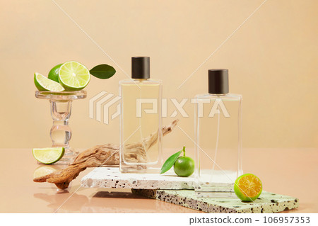 Transparent bottles decorated with fresh limes and kumquats on the stone podiums. Lime and Kumquat can help your body fight off infections 106957353