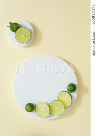 Two white podiums with round slices of lime and kumquat placed on. Minimalist mockup for podium display or showcase your product extracted from Lime and Kumquat 106957379