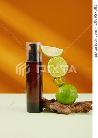 Pump bottle dispenser without label decorated with limes and kumquats over light background. Limes and kumquats are high in vitamin C, antioxidants, and other nutrients 106957393