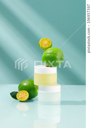 Two jars in pastel color stacked on each other with limes and kumquats featured. Eating Lime and Kumquat fruit or drinking juice provides a variety of health benefits 106957397