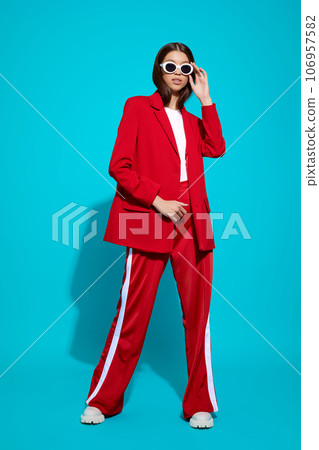 Fashion asian female model in red suit, white boots and sunglasses. Fashion asian female model in red suit, white boots and sunglasses. 106957582