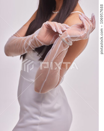 Female hands in transparent black gloves on dress background. Retro style.. Female hands in transparent black gloves on dress background. Retro style.. 106957688