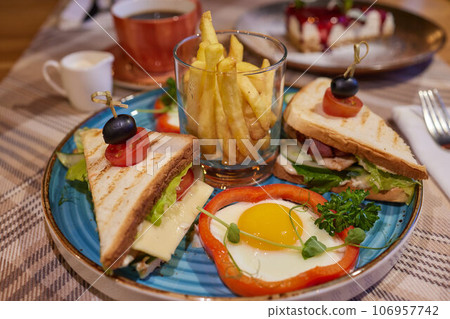 Scrambled egg sandwich with cream cheese on rye toast for breakfast on white background. Healthy breakfast or snack. 106957742