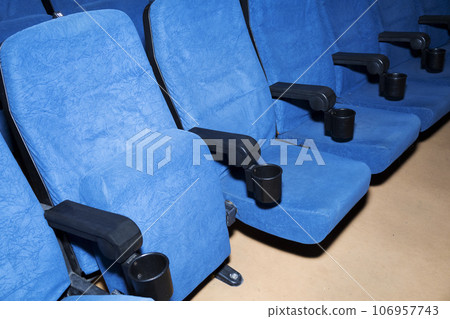 Modern cinema hall empty and blue comfortable seats, movie theater seats or chair Modern cinema hall empty and blue comfortable seats, movie theater seats or chair 106957743
