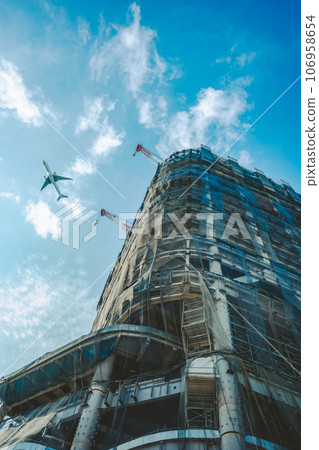 Cranes at a large-scale construction site and passenger planes above Takanawa Gateway 2023.09 Film style Cranes at a large-scale construction site and passenger planes above Takanawa Gateway 2023.09 Film style 106958654