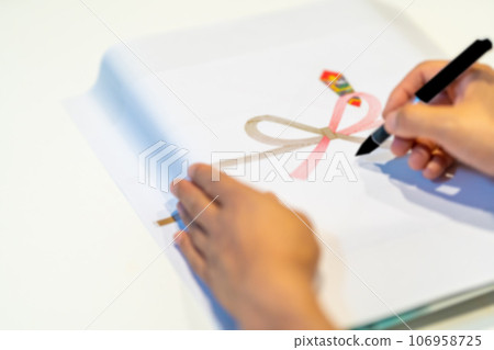 Add your hand and write your name by hand on the paper Add your hand and write your name by hand on the paper 106958725