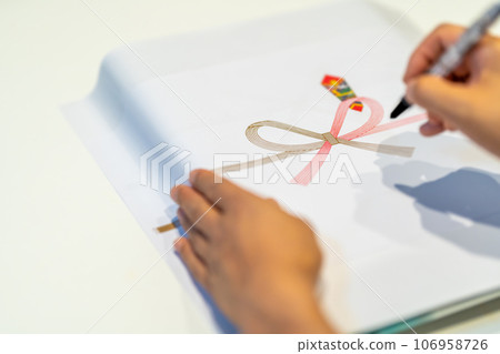 Write your name on the paper with a pen 106958726