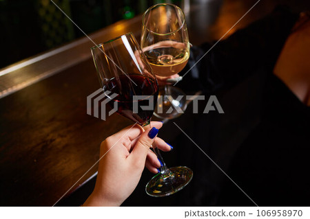 Clinking glasses with alcohol and toasting, party. 106958970