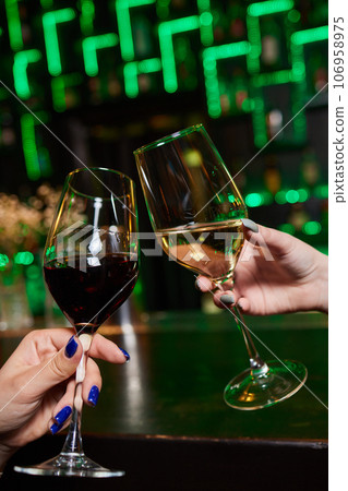 Clinking glasses with alcohol and toasting, party. 106958975