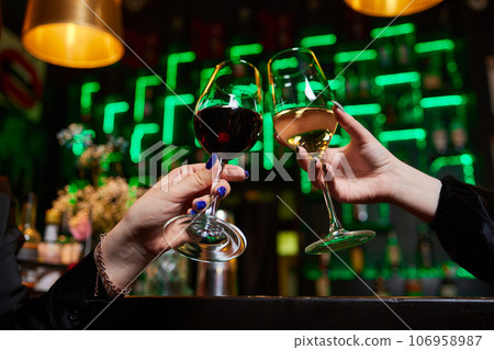 Clinking glasses with alcohol and toasting, party. Clinking glasses with alcohol and toasting, party. 106958987