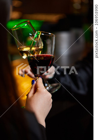 Clinking glasses with alcohol and toasting, party. 106958990