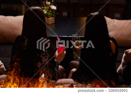 Clinking glasses with alcohol and toasting, party. 106958991