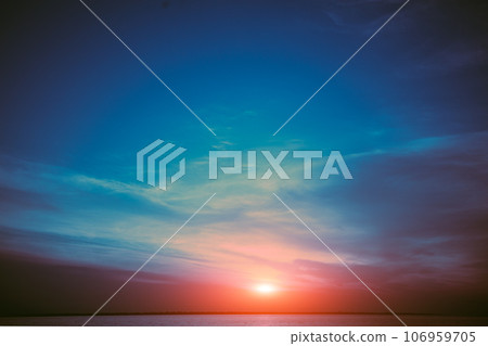 Colorful cloudy sky over the sea at sunset. Sky texture, abstract nature background Colorful cloudy sky over the sea at sunset. Sky texture, abstract nature background 106959705