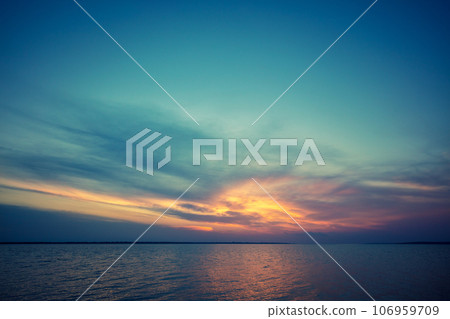 Seascape in the early morning. Sunrise over the sea. Calm sea with beautiful sky. Nature landscape Seascape in the early morning. Sunrise over the sea. Calm sea with beautiful sky. Nature landscape 106959709