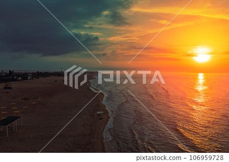 Seascape in the early morning. Sunrise over the sea. Calm sea with beautiful sky. Nature landscape. Sandy beach in summer Seascape in the early morning. Sunrise over the sea. Calm sea with beautiful sky. Nature landscape. Sandy beach in summer 106959728