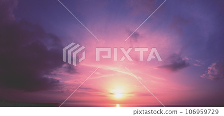 Horizontal panorama of a dramatic glowing cloudy sky at sunset. Sky texture. Abstract nature background Horizontal panorama of a dramatic glowing cloudy sky at sunset. Sky texture. Abstract nature background 106959729