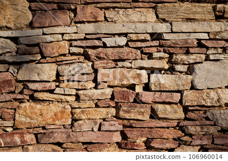 Sturdy yellow and beige cut stone wall made in Datca, Turkey, seamless lined up Sturdy yellow and beige cut stone wall made in Datca, Turkey, seamless lined up 106960014