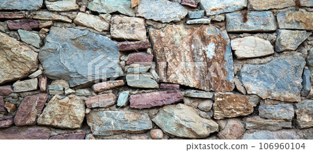 Sturdy yellow and beige cut stone wall made in Datca, Turkey, seamless lined up Sturdy yellow and beige cut stone wall made in Datca, Turkey, seamless lined up 106960104