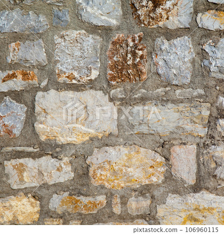 Sturdy yellow and beige cut stone wall made in Datca, Turkey, seamless lined up Sturdy yellow and beige cut stone wall made in Datca, Turkey, seamless lined up 106960115