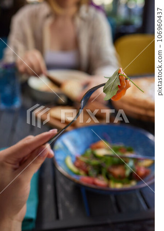 Young woman eating healthy salad at restuarant, Healthy lifestyle, diet concept. Young woman eating healthy salad at restuarant, Healthy lifestyle, diet concept. 106960437