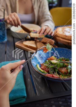 Young woman eating healthy salad at restuarant, Healthy lifestyle, diet concept. Young woman eating healthy salad at restuarant, Healthy lifestyle, diet concept. 106960439