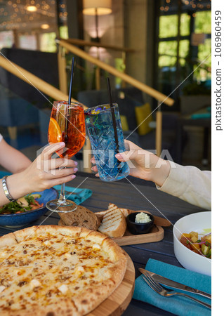 Clinking glasses with alcohol and toasting, party. 106960459