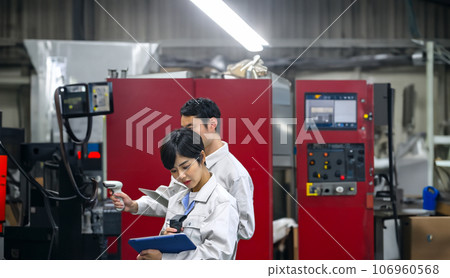 Engineer inspecting factory machinery Engineer inspecting factory machinery 106960568