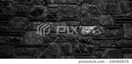 Sturdy black and white cut stone wall made in Datca, Turkey, seamless lined up 106960676