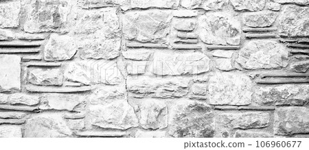 Sturdy black and white cut stone wall made in Datca, Turkey, seamless lined up 106960677