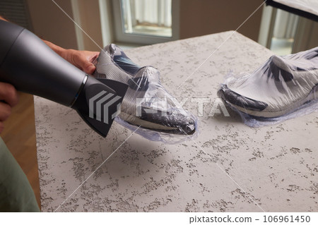vacuum packing sneakers. for seasonal storage close-up. vacuum packing sneakers. for seasonal storage close-up. 106961450