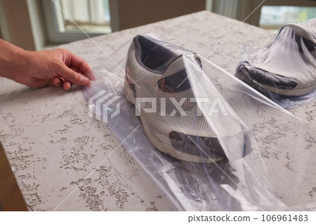 vacuum packing sneakers. for seasonal storage close-up. vacuum packing sneakers. for seasonal storage close-up. 106961483