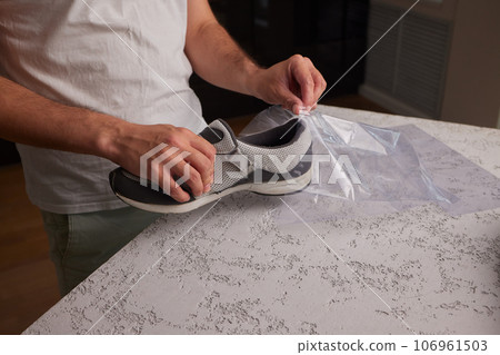 vacuum packing sneakers. for seasonal storage close-up. 106961503