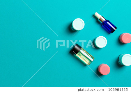 Cosmetics SPA branding mock-up, top view with copy space. set of tubes and jars of cream flat lay on colored background 106961535